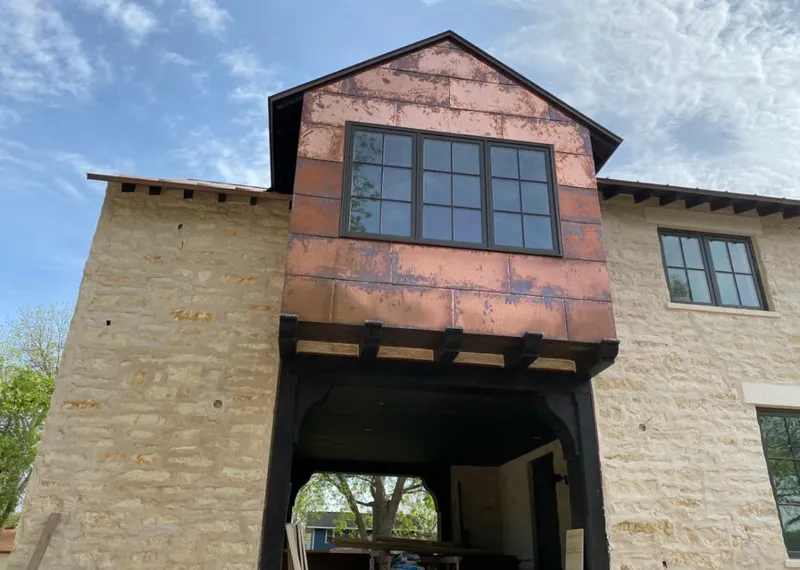 Copper metal panel facade on a stone building for Skylight Installation in Bismarck